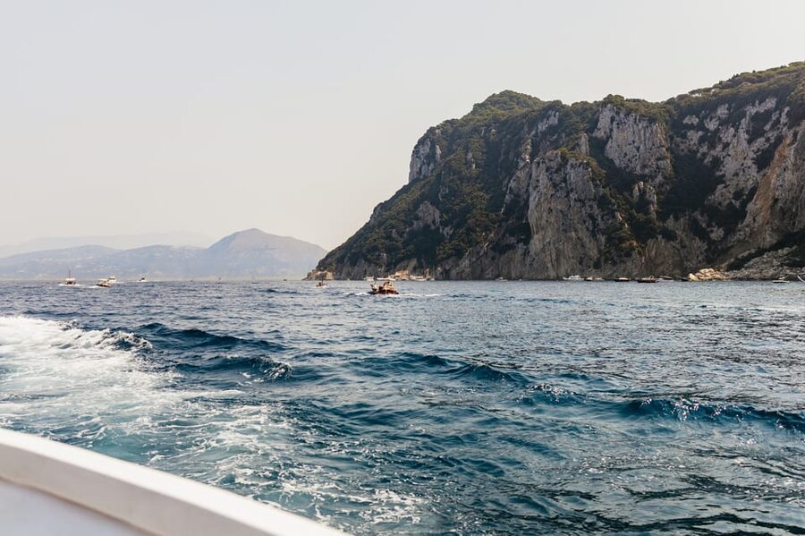 Capri: Island Boat Tour and Optional Blue Grotto Visit - Onboard experience: skipper commentary, language, and where to sit